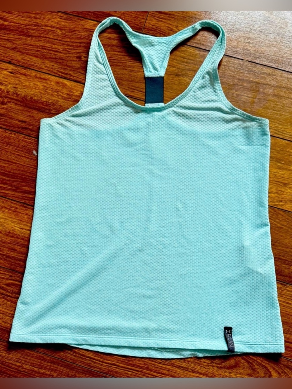 Under Armour racerback running tank top with a breathable mesh texture